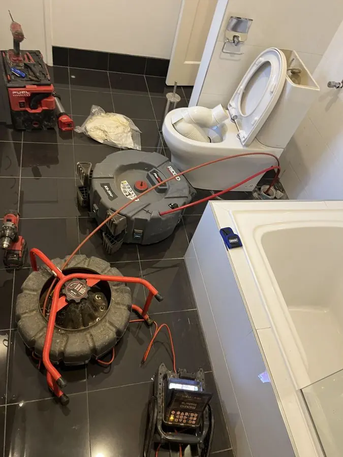 Drain clearing equipment in a bathroom, Highett