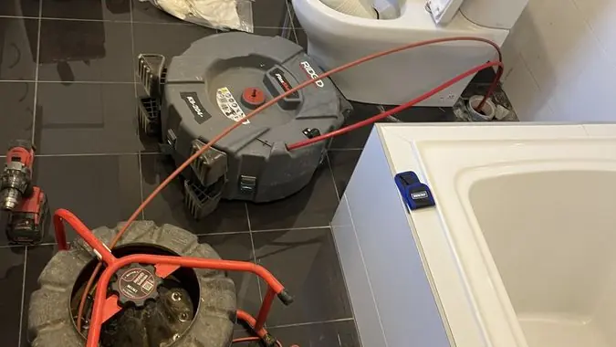 Drain clearing equipment in a bathroom, Highett